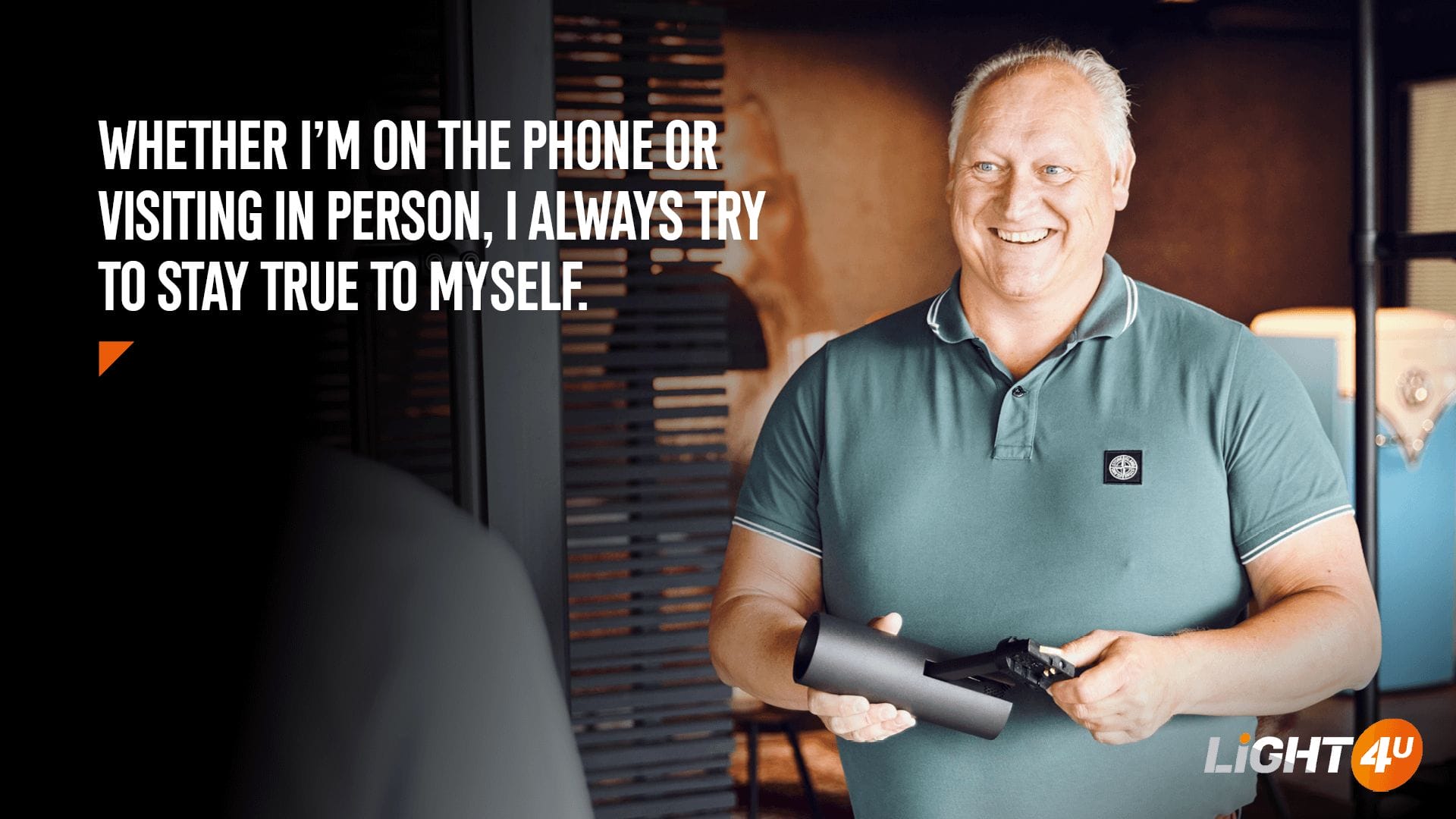 Portrait of Jos Pol, Senior Account Manager at Light4U, holding a lighting fixture. The quote reads: "Whether I'm on the phone or visiting in person, I always try to stay true to myself."
